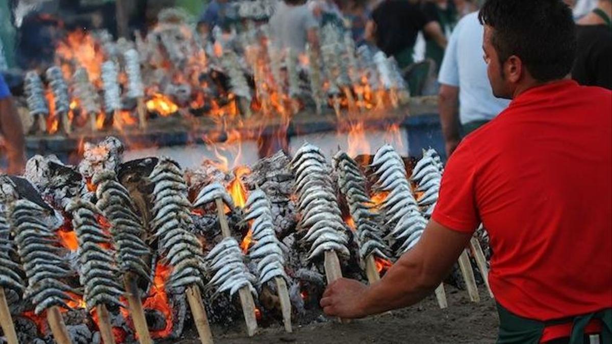 Un espetero asa varios espetos de sardinas