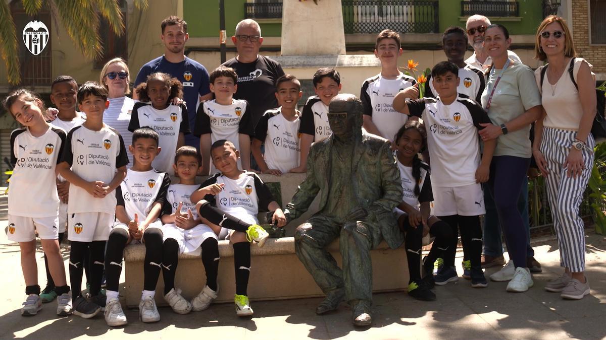 Les xiquetes i xiquets d'Escoles Cor Blanc i negre junt amb l'estatua del poeta Vicent Andrés Estellés a Burjassot.