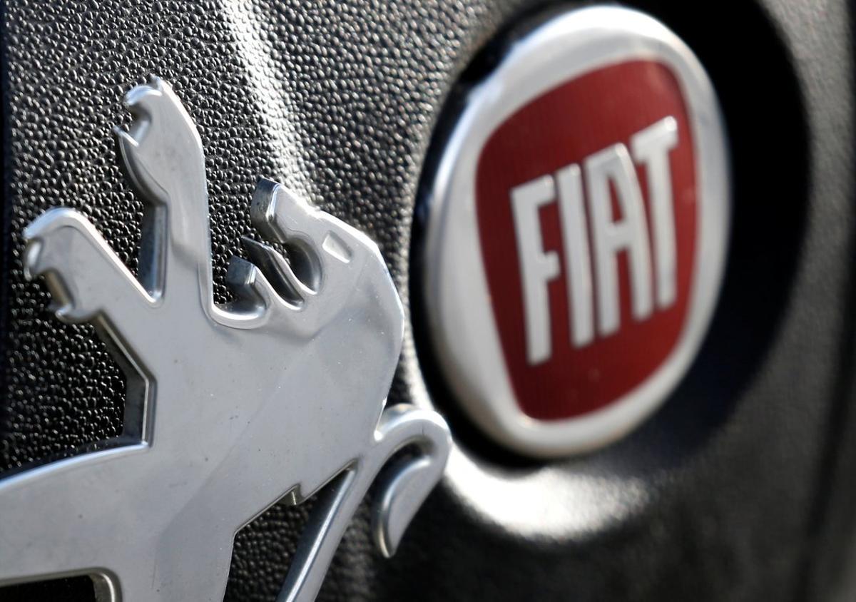 Logos of Peugeot and Fiat are seen in this illustration picture taken October 30, 2019. REUTERS/Regis Duvignau/Illustration