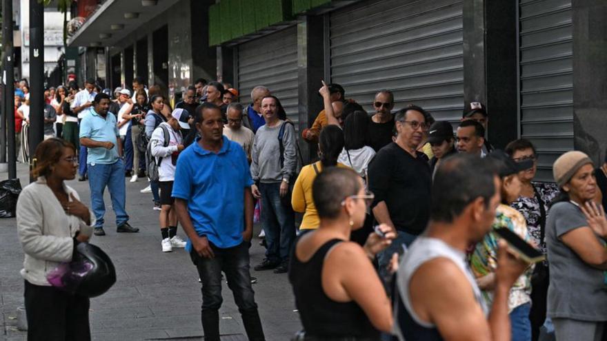 Veneçolans fan cua en un supermercat, ahir a Caracas. | JUAN BARRETO / AFP
