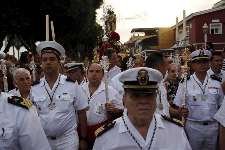 Sailors take part in the procession of the El Carmen Virgin, on its way to be carried into the sea, in Malaga