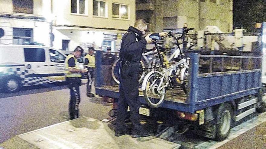 Un agente de la Policía Local retira una de las bicicletas tras el atropello en la Porta de Sant Antoni.