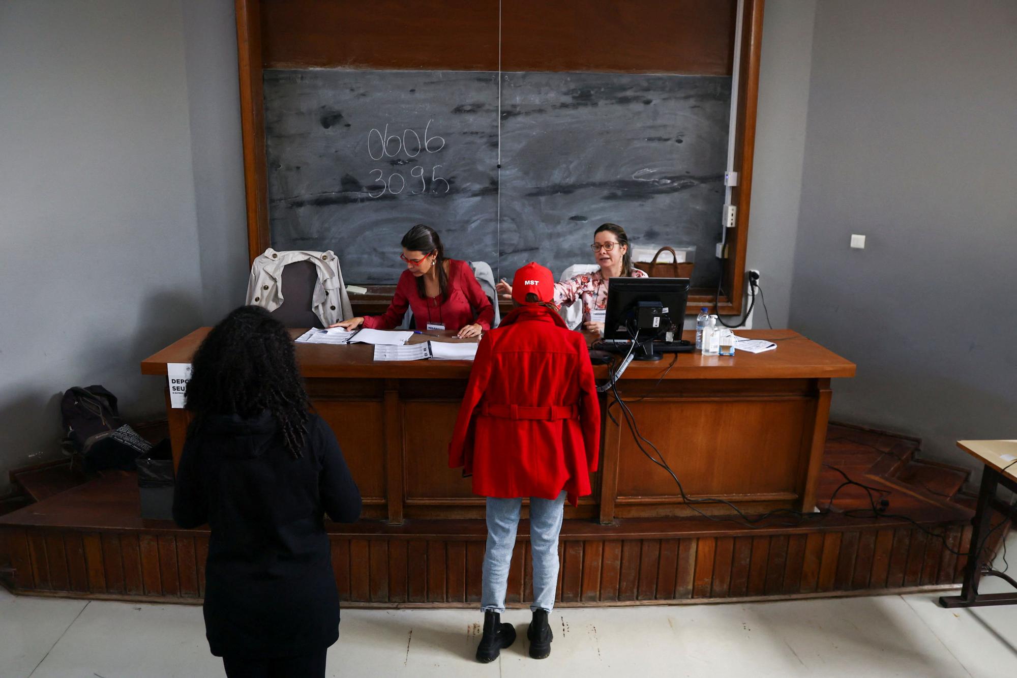 Citizens of Brazil present their identification to cast their votes for their country's election, in Lisbon