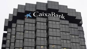 El logo de CaixaBank, en lo alto de la sede central de la entidad, en Barcelona.