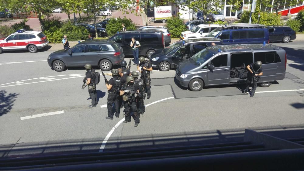 German special police leave their cars after a ...