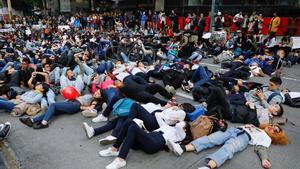 Demonstrators lie on the ground during a protest as a national strike continues in Bogota, Colombia November 26, 2019. REUTERS/Carlos Jasso