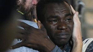 A migrant reacts as he disembarks the Spanish rescue ship Open Arms NGO, after it arrived in Lampedusa, Italy, August 20, 2019. REUTERS/Guglielmo Mangiapane