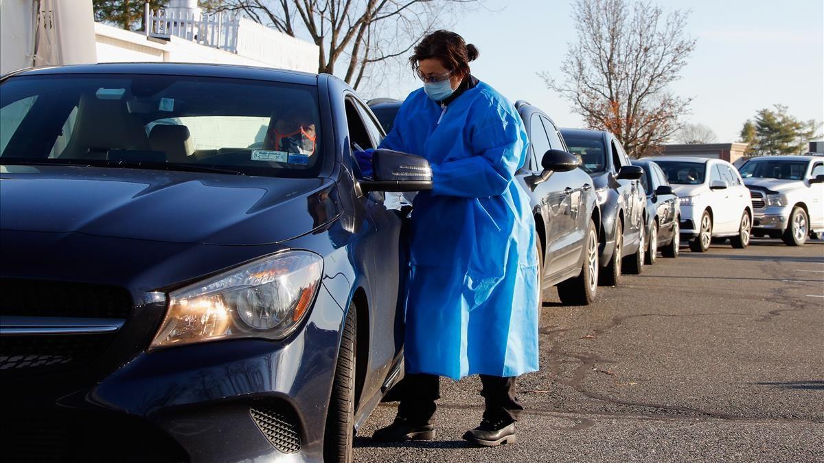 JERICHO  NEW YORK - DECEMBER 03  Health care workers tend to patrons who arrive for rapid COVID-19 tests at ProHealth Care on December 03  2020 in Jericho  New York  Earlier today  ProHealth opened rapid test drive-thru facilities at six locations in New York City and on Long Island    Bruce Bennett Getty Images AFP    FOR NEWSPAPERS  INTERNET  TELCOS   TELEVISION USE ONLY