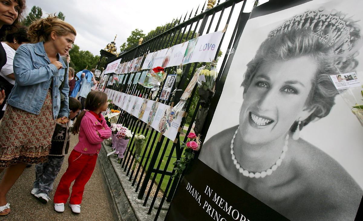 Fotografías, mensajes y flores en recuerdo de Diana de Gales se amontonan a la entrada del palacio de Kensington, en Londres, Reino Unido, en el décimo aniversario de su muerte.