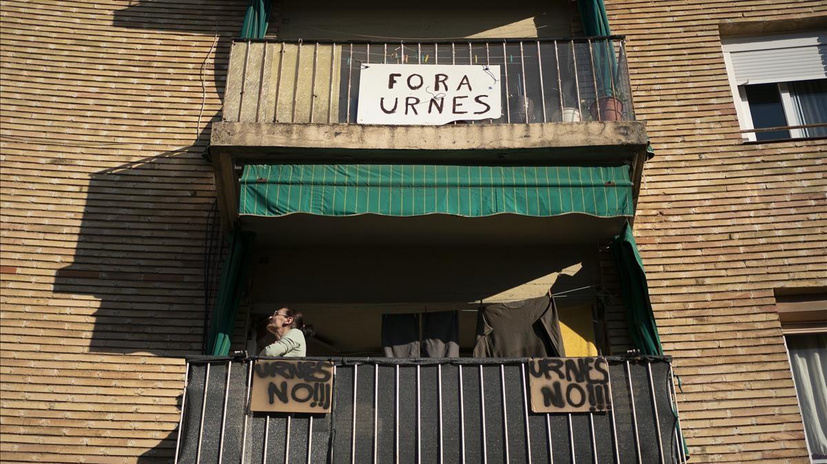 Una vecina, en uno de los balcones que dan al columbario, entre carteles de protesta.