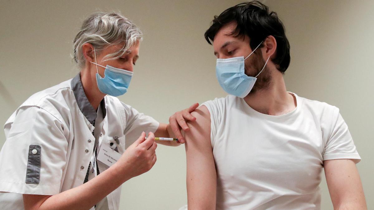 FILE PHOTO: A volunteer receives a dose of CureVac vaccine or a placebo, in Brussels