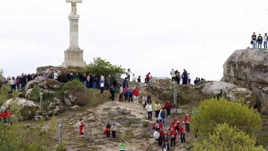 Procesión rodeando la cruz tras la misa campestre de mediodía, ayer, en A Picaraña.  // A. Hernández