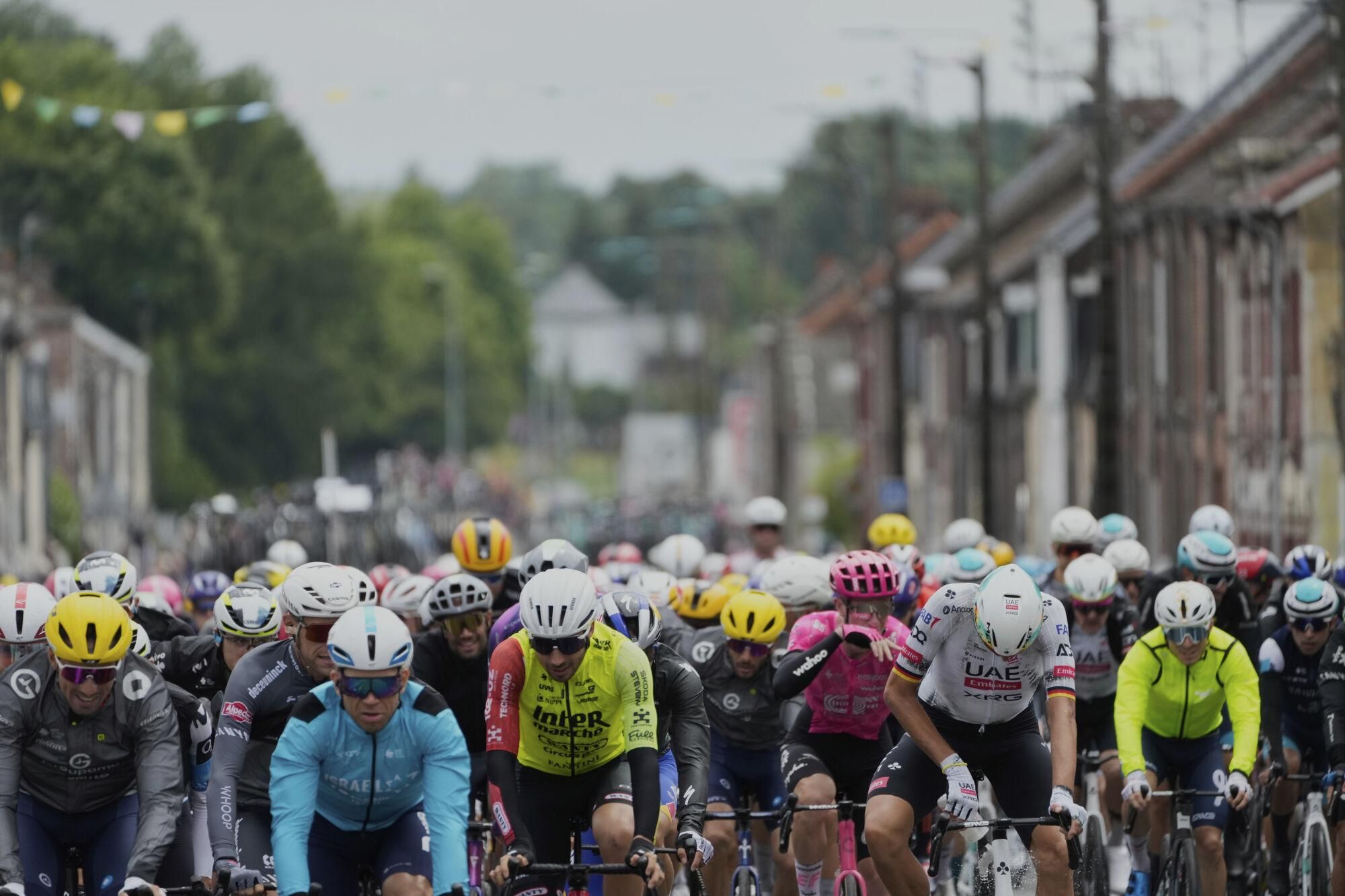 The pack rides during the third stage of the Tour de France cycling race over 178.3 kilometers (110.8 miles) with start in Valenciennes and finish in Dunkerque, France, Monday, July 7, 2025. (AP Photo/Mosa'ab Elshamy)
