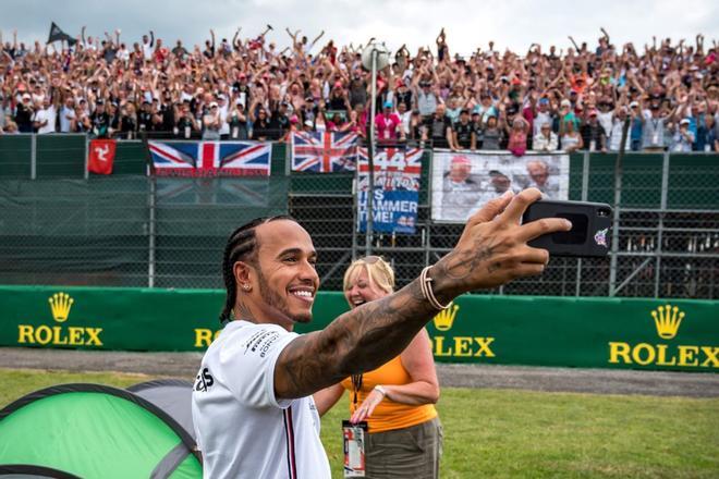 El piloto británico de Mercedes, Lewis Hamilton, toma una fotografía autofoto con sus seguidores en el circuito de carreras de Silverstone en Silverstone, en el centro de Inglaterra, antes del Gran Premio de Fórmula Uno británico.