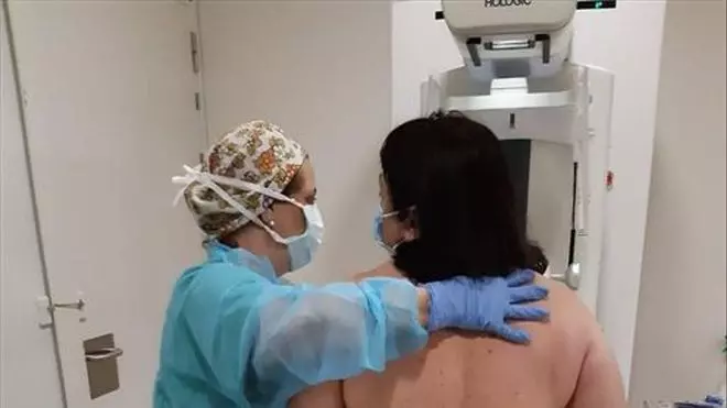 Woman undergoing mammogram