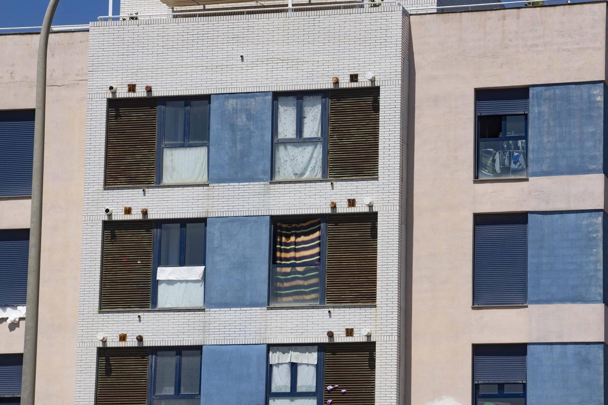 Ventanas arrancadas y cubiertas con telas en los pisos okupados de la avenida Germanías de Carcaixent.