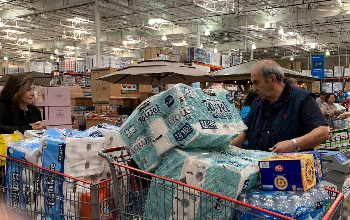 Customers wait in line to buy water and other supplies, on fears that the coronavirus, COVID-19, will spread and force people to stay indoors,  at a Costco in Burbank, California on March 6, 2020. - US lawmakers passed an emergency  USD 8.3 billion spending bill to combat the coronavirus on Thursday as the number of cases surged in the country’s northwest and deaths reached 12. Since then the toll has risen to 12 and the virus has spread to at least 15 states -- the latest being Maryland adjacent to the nation’s capital Washington. (Photo by Robyn BECK / AFP)