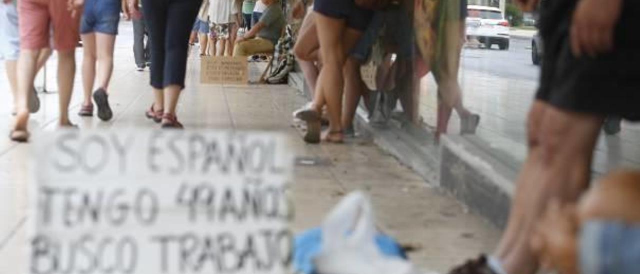 Cartel de una persona pidiendo limosna en el centro de Alicante.