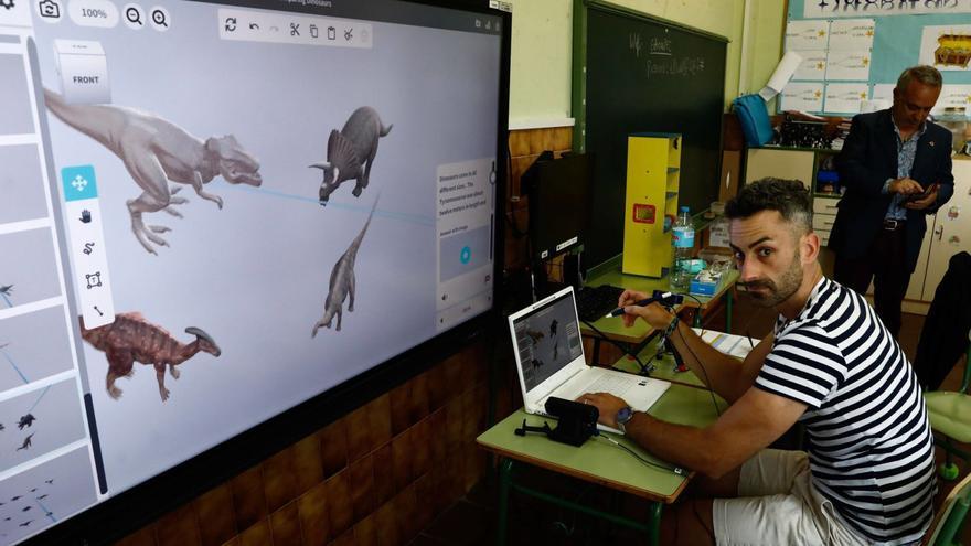 Alejandro Arboleya, con el ordenador que permite trabajar con hologramas y con las imágenes que aparecen en el portátil proyectadas en la pantalla instalada en la pared del aula.