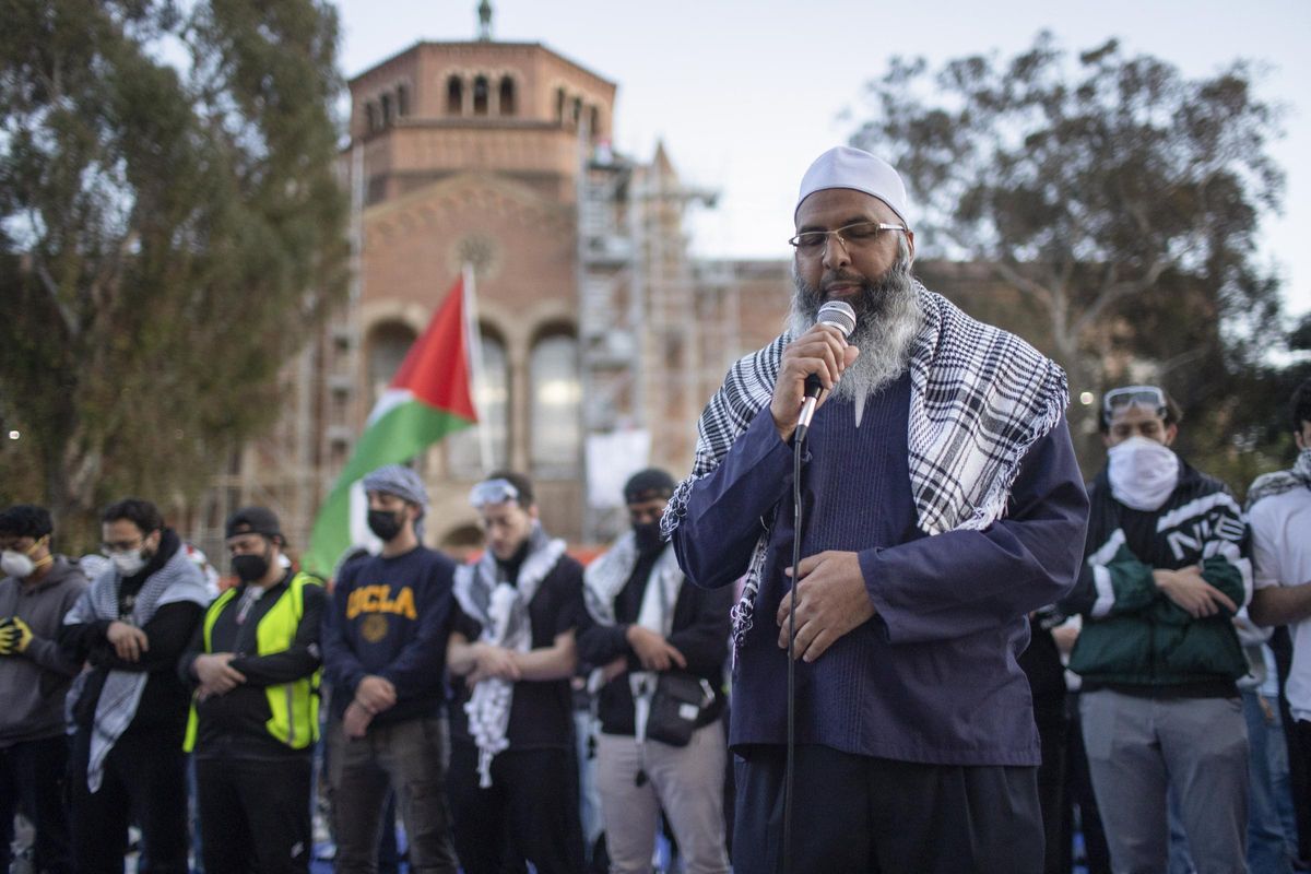 Pro-Palestinian demonstrators pray on the UCLA campus Wednesday, May 1, 2024, in Los Angeles. (AP Photo/Ethan Swope)