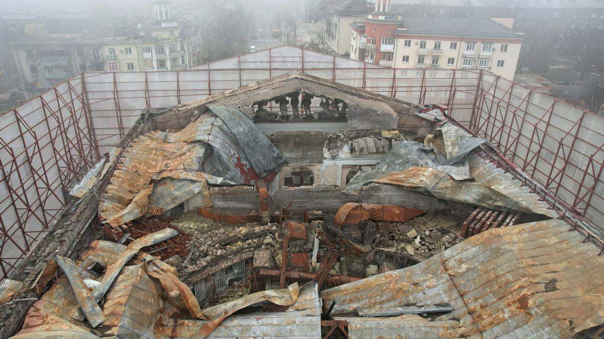 A view shows a fenced theatre building destroyed in the course of Russia-Ukraine conflict in Mariupol