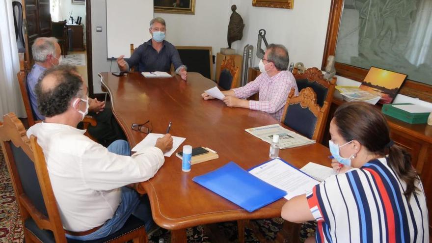 El alcalde (al fondo) en una reciente reunión con Emgrobes para debatir sobre la Festa do Marisco.