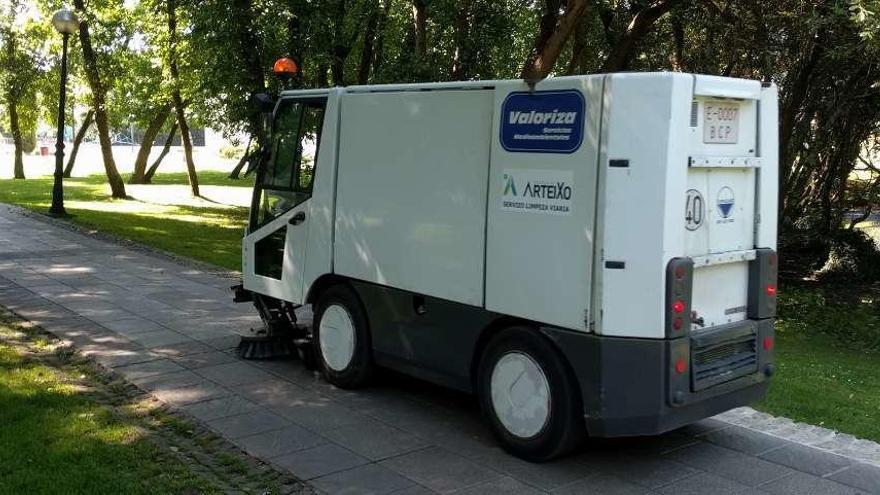 Un vehículo del servicio de limpieza viaria de Valoriza recorre el paseo fluvial de Arteixo.