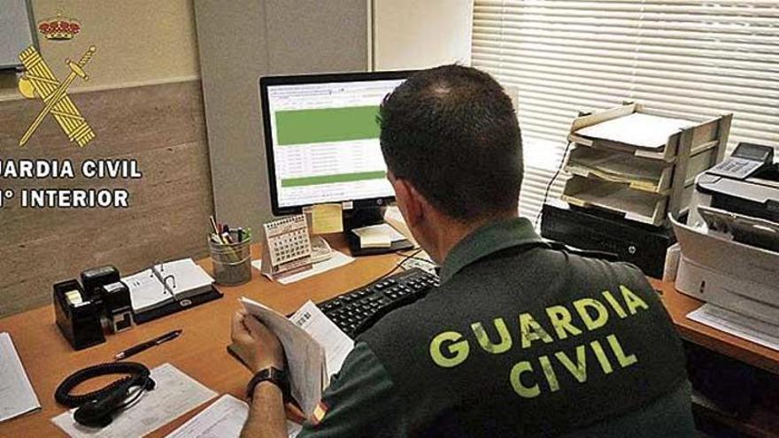 Un agente de la Guardia Civil investiga una presunta estafa.