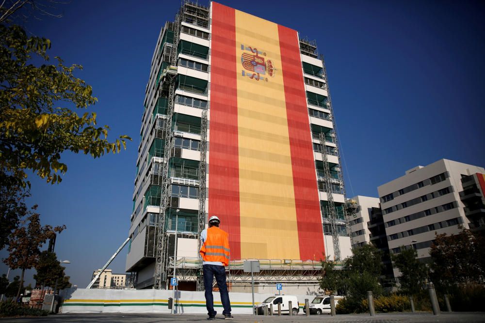 A construction worker looks at a new apartment ...