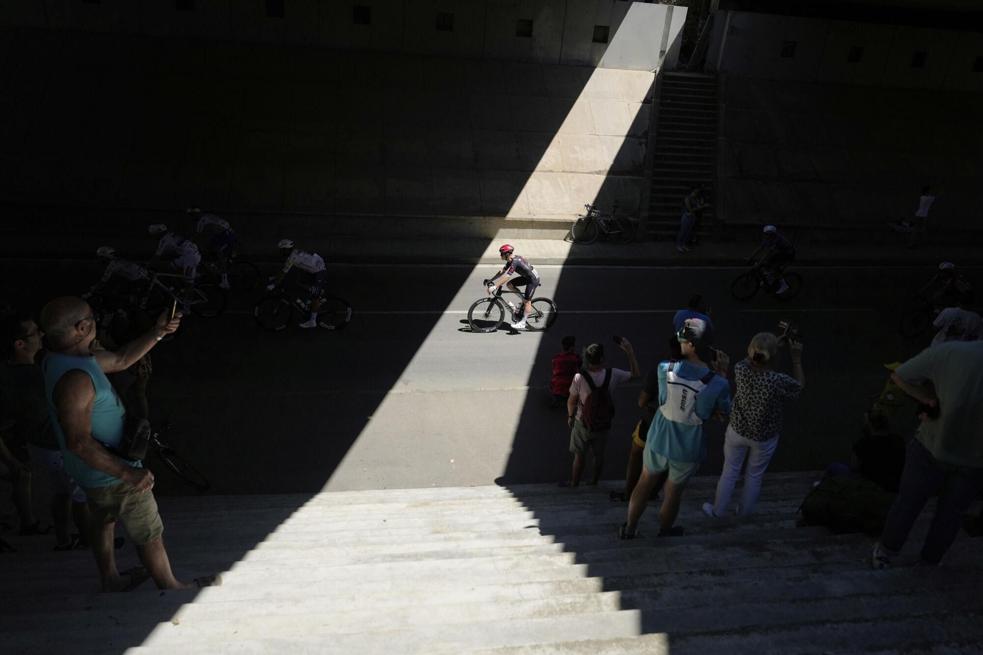 Spectators take photos of the riders during the eleventh stage of the Tour de France cycling race over 156.8 kilometers (97.4 miles) with start and finish in Toulouse, France, Wednesday, July 16, 2025. (AP Photo/Mosa'ab Elshamy)