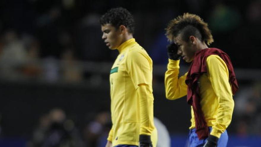 Los jugadores de la selección de Brasil Thiago Silva y Neymar se retiran del terreno de juego tras empatar frente a Venezuela.