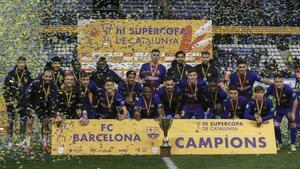 La plantilla del Barça posa con el trofeo de la Supercopa de Catalunya en la final ganada al Espanyol en Lleida por penaltis (4-2)