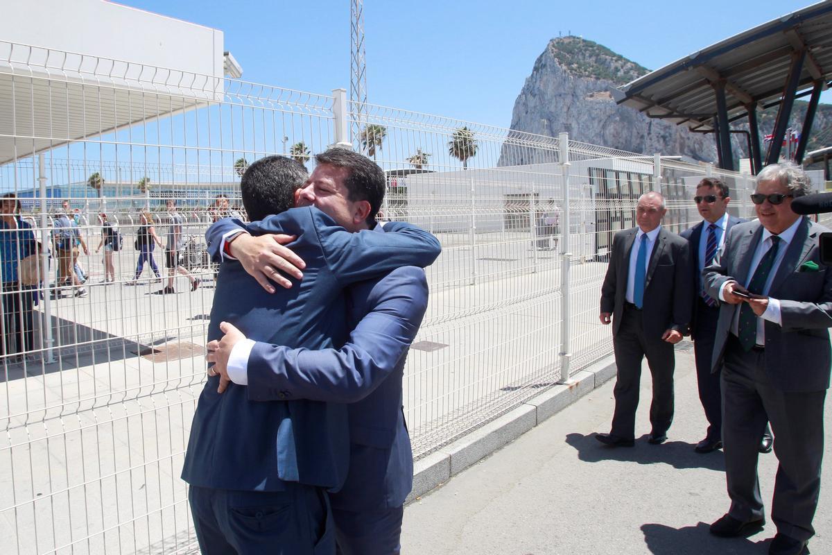 El alcalde de La Línea de la Concepción (Cádiz), Juan Franco, y el ministro principal de Gibraltar, Fabian Picardo, se abrazan delante de la verja de Gibraltar y España en un acto con el que la localidad gaditana y la colonia británica cierran los actos que han organizado para conmemorar el 50 aniversario del cierra de la verja.