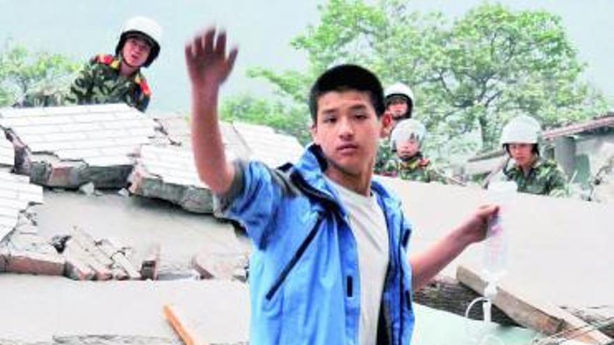 Bomberos rescatan los cadáveres de varios niños del Colegio de Dujiangyan.