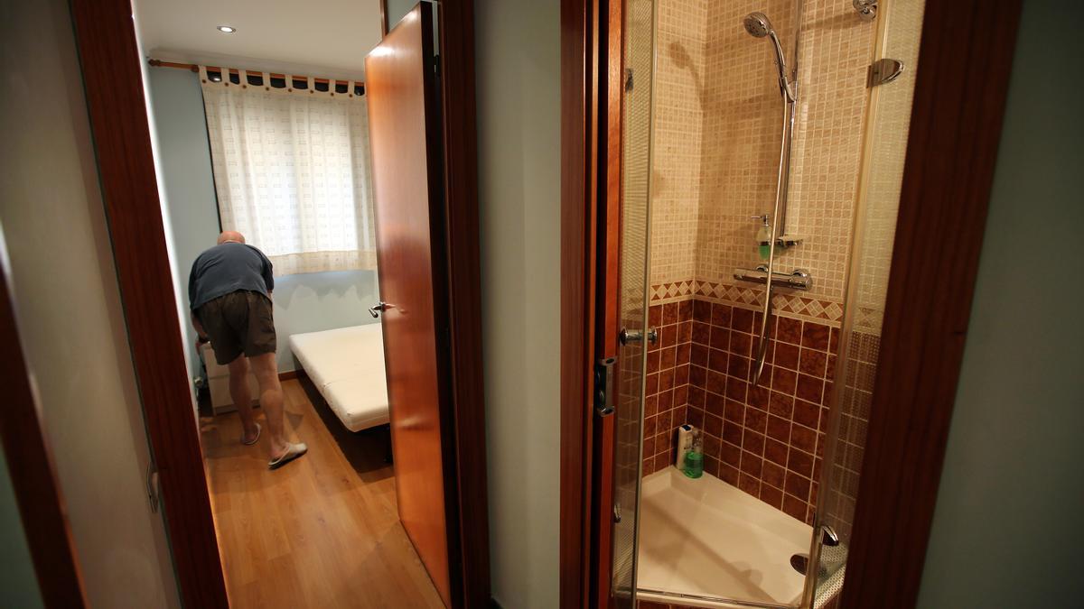 José Luis Samaniego, muestra la habitación que alquila y el baño contiguo, en su domicilio del barrio del Camp de l'Arpa del Clot.