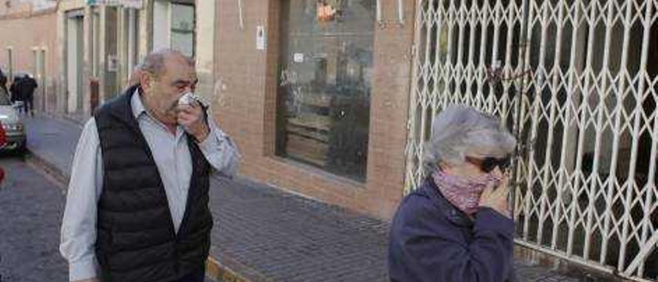 Vecinos se tapan la nariz al pasar por delante del local del que salen a la calle las aguas residuales y detalles del estado del local.