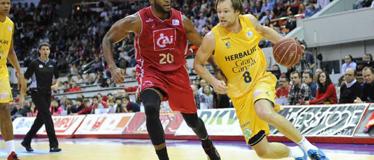 El alero australiano del Herbalife Gran Canaria, Brad Newley, busca una penetración ante la defensa de Jason Robinson, jugador del CAI Zaragoza en el partido de la jornada 16.