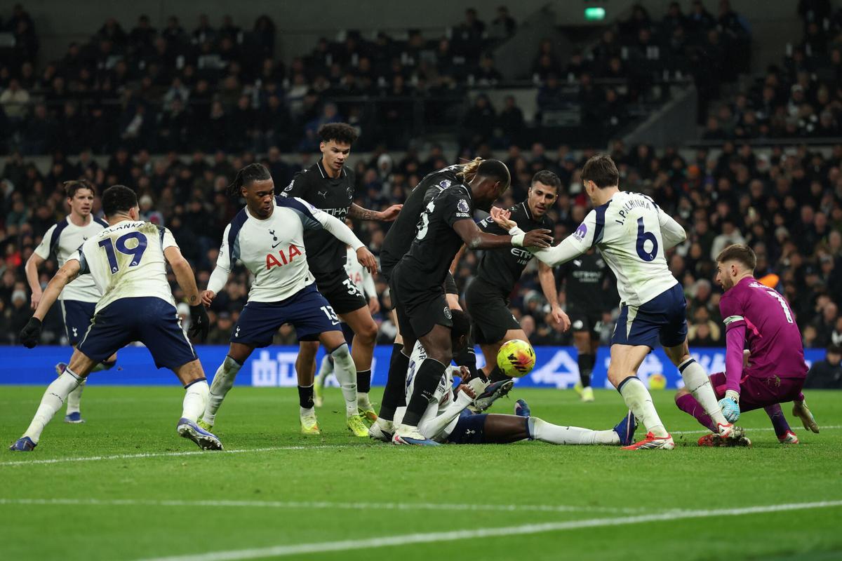 Tottenham's Pape Matar Sarr, bottom, blocks a shot by Manchester City's Marc Guehi, center, during the English Premier League soccer match between Tottenham Hotspur and Manchester City in London, Sunday, Feb. 1, 2026. (AP Photo/Richard Pelham)