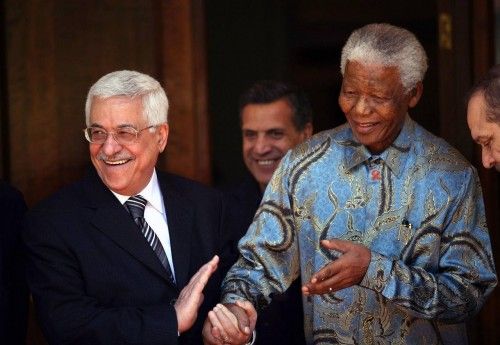 Palestinian President Abbas shares light moment with former South African President Mandela at Mandela's house in Johannesburg, South Africa