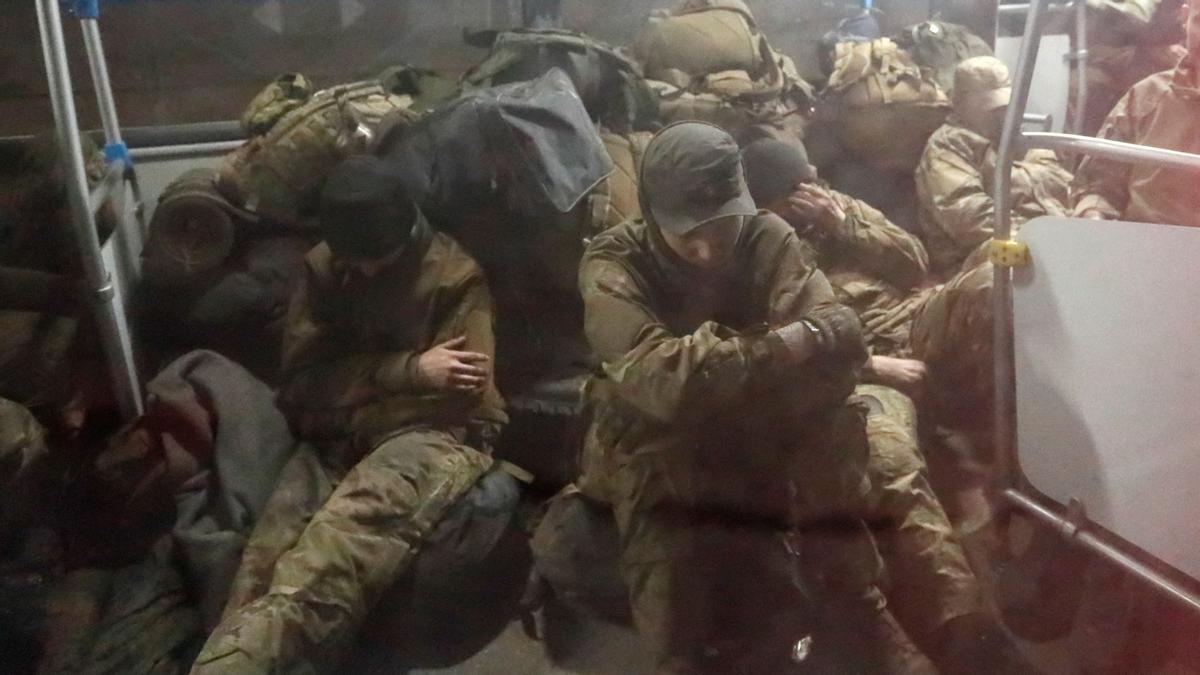 Service members of the Ukrainian armed forces, who surrendered at the besieged Azovstal steel mill in Mariupol in the course of Ukraine-Russia conflict, sit in a bus upon their arrival under escort of the pro-Russian military in the settlement of Olenivka in the Donetsk region, Ukraine May 20, 2022. REUTERS/Alexander Ermochenko