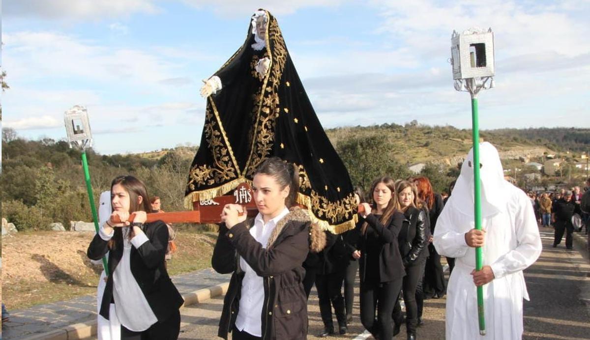 Las jóvenes portan la imagen de la Virgen Dolorosa durante la procesión del Santo Entierro de Bercianos.