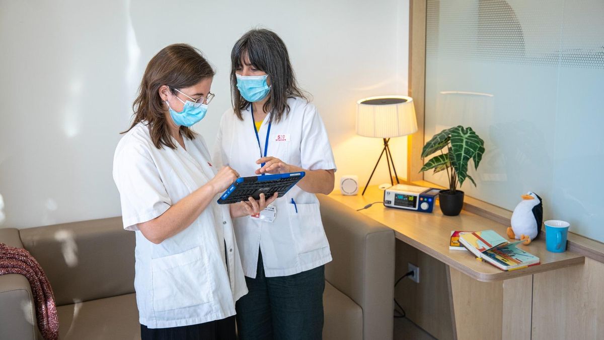 Elena Codina (izquierda), pediatra de Sant Joan de Déu, y Ane Achotegui, enfermera del mismo centro, revisando los datos registrados en el domicilio de un paciente.