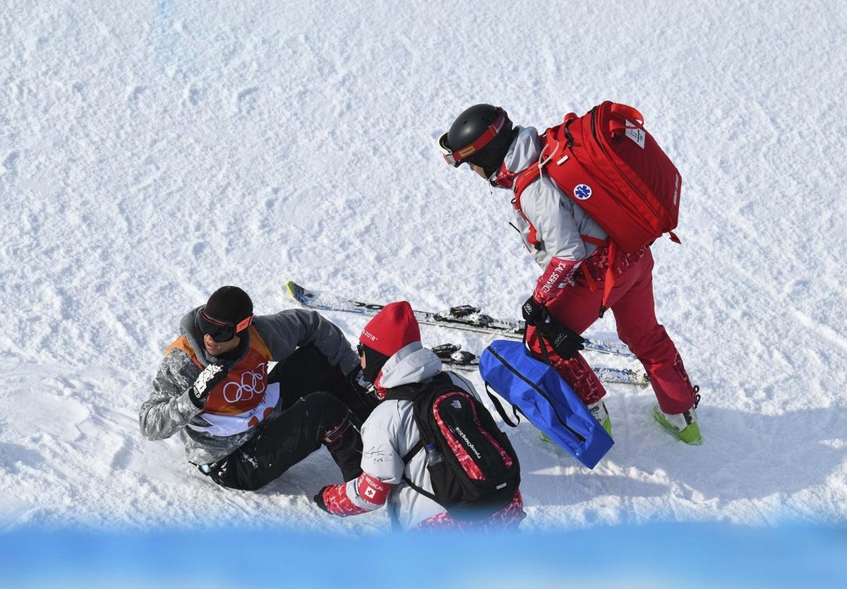Freestyle Skiing - Pyeongchang 2018 Winter Olympics - Men’s Ski Halfpipe Qualifications - Phoenix Snow Park - Pyeongchang, South Korea - February 20, 2018 - Officials tend to Joel Gisler of Switzerland after his crash.  REUTERS/Dylan Martinez