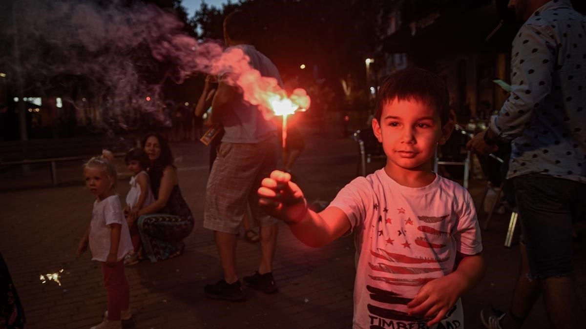 Unos niños disfrutando con sus bengalas en la avenida Mistral