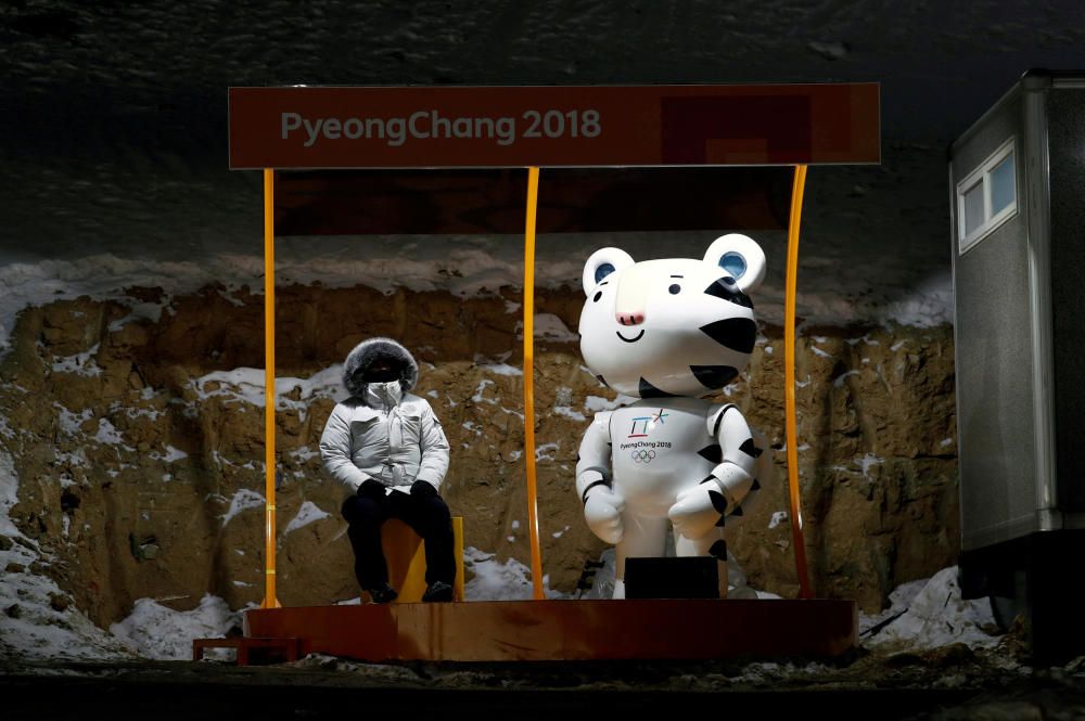 A fan sits next to Soohorang, the Olympic ...