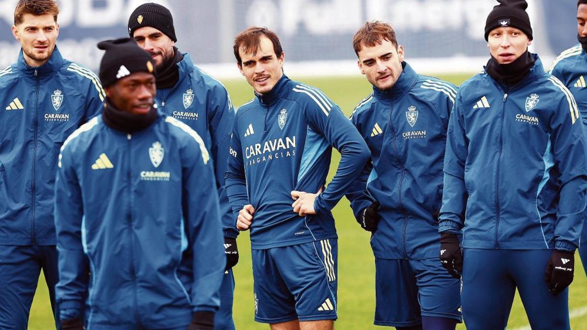 Francho Serrano, en el centro de la imagen, rodeado por Valery, Cuenca, Saidu, Insua y Kosa en el entrenamiento de ayer del Zaragoza en la Ciudad Deportiva.