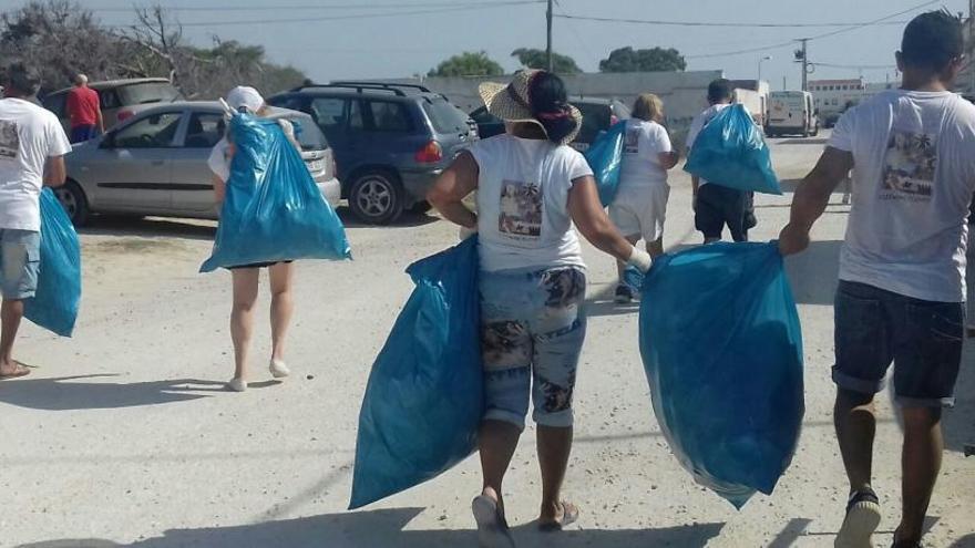 Voluntarios con basura recogida en la pinada de La Marina.