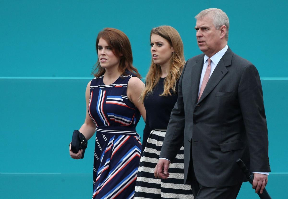 (FILES) (L-R) Britain's Princess Eugenie of York, Britain's Princess Beatrice of York and Britain's Prince Andrew, Duke of York leave Buckingham Palace to meet guests at the Patron's Lunch, a special street party outside Buckingham Palace in London on June 12, 2016, as part of the three day celebrations for Queen Elizabeth II's official 90th birthday. UK police said on February 19, 2026 officers were searching two addresses, one in eastern England and one west of London, following the arrest of ex-Prince Andrew on suspicion of misconduct in a public office. New revelations last week appeared to show Andrew sent convicted sex offender Jeffrey Epstein potentially confidential documents during his time as a UK trade envoy. (Photo by JUSTIN TALLIS / AFP)