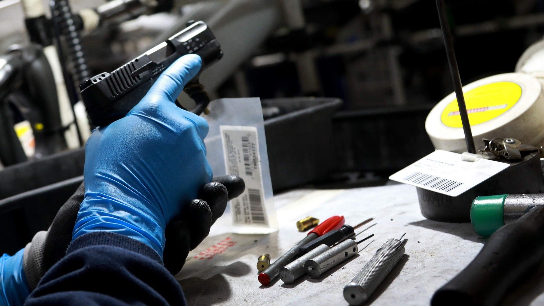 Un trabajador de la empresa brasileña Taurus, una de las mayores fabricantes de armas del mundo, manipula una pistola, en junio de 2019.