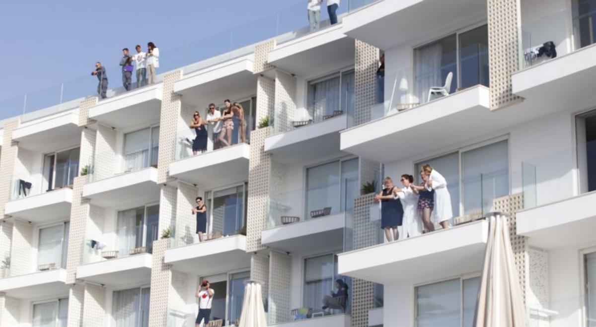 Turistas asomados a los balcones. | J.A. RIERA